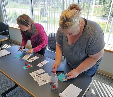 Becky and Kari checking quality during a Lean training exercise at MCL.
