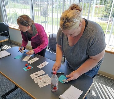 Becky and Kari checking quality during a Lean training exercise at MCL.