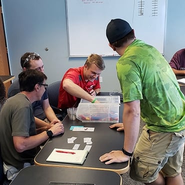 Brock tries to find parts in the store during a Lean training exercise at MCL.