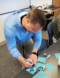 Jake writes a PO during a Lean training exercise at MCL.